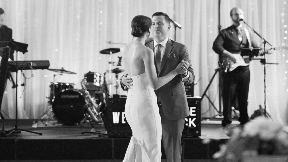 Couple dancing together while Weekend ComeBack performs live at a Michigan wedding reception