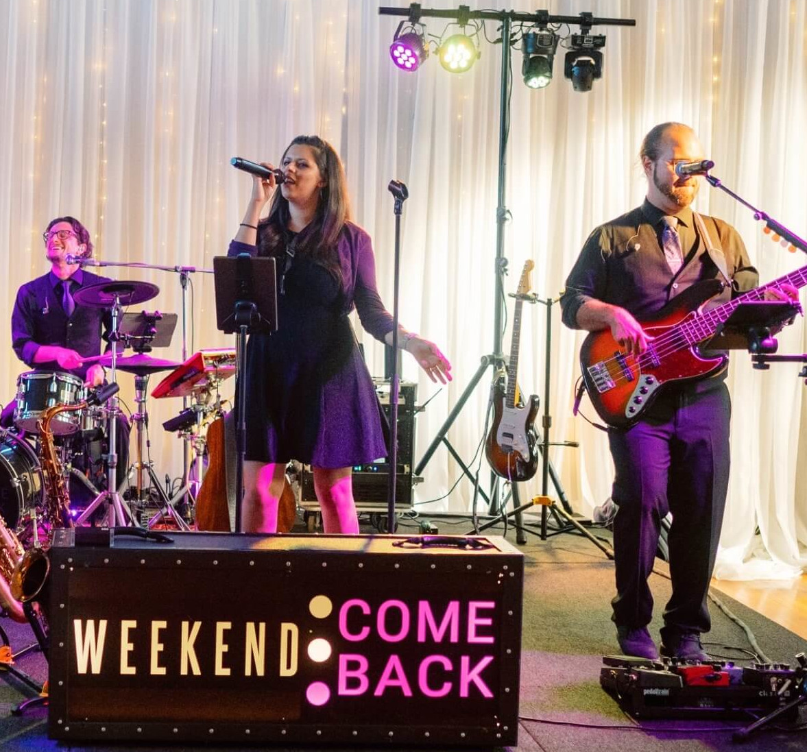 Packed dance floor with arms in the air at Uccello's Grand Rapids wedding reception