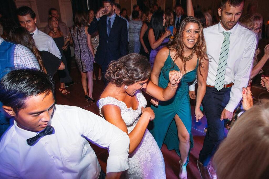 Bride dancing with guests at a packed Colony Club Detroit wedding reception