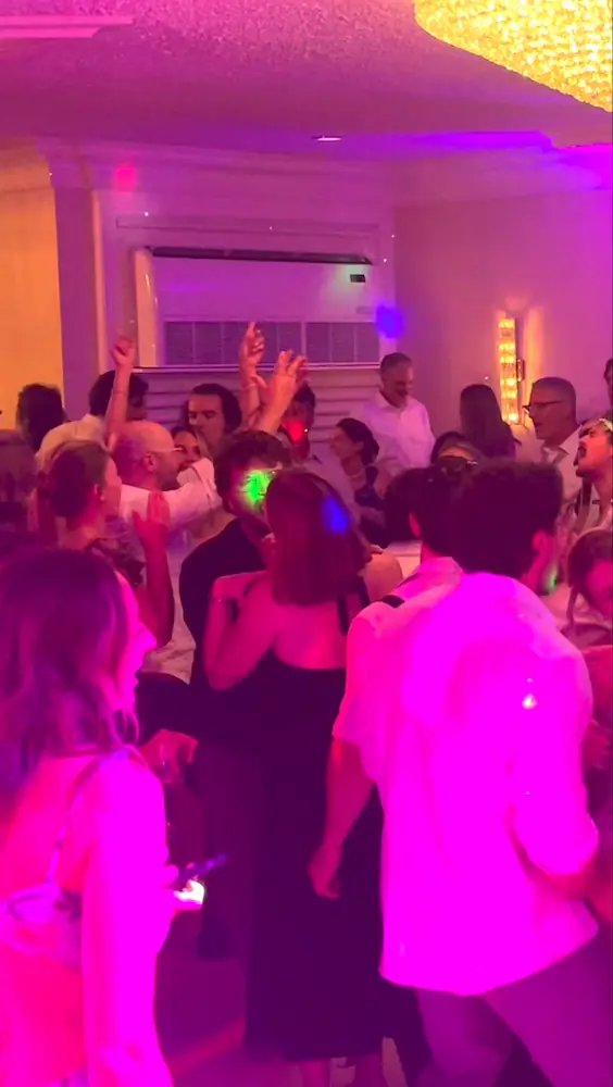 Packed wedding dance floor with guests dancing and singing during a Weekend ComeBack live wedding performance